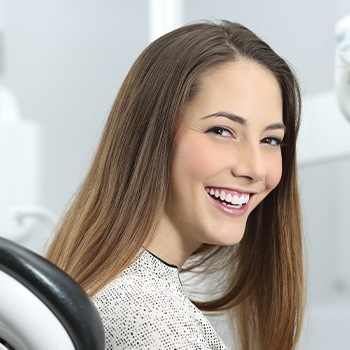 young woman smiling after receiving advanced dental technology