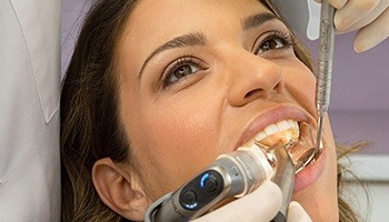 A female patient undergoing dental work while the dentist uses the Isolite System