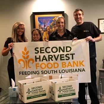 Team members holding food bank sign