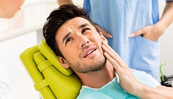 Male patient consulting doctor about tooth pain