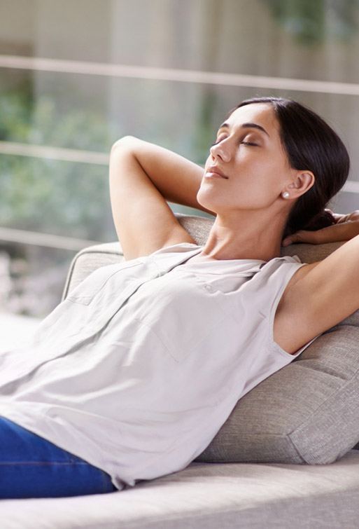 Completely relaxed woman lying on couch