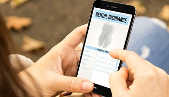 Looking at dental insurance form on phone