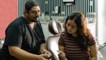 A dentist explaining Invisalign treatment to a patient
