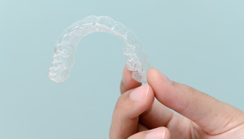 Patient holding clear aligner