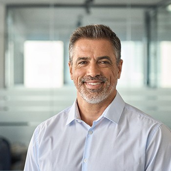 Man in button up shirt smiling