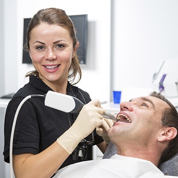 Dental hygienist cleaning a patient’s teeth