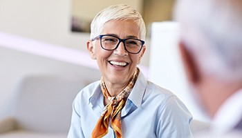 Woman with glasses smiling in business meeting