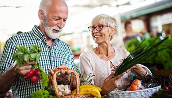 older couple shopping for fruits and vegetables 