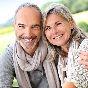 Aged couple exchanging bright smiles