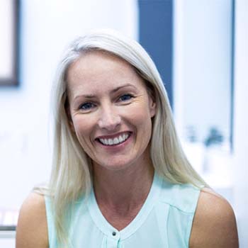 Female patient smiling after tooth extraction in Metairie, LA