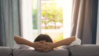 Woman resting at home after tooth extraction in Metairie, LA