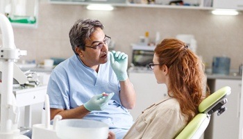 dentist talking to woman red hair