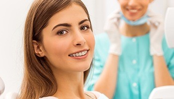 Woman in white shirt sporting braces