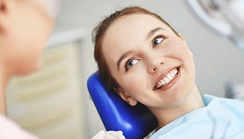 Female patient greeting dentist with a big smile