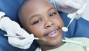 Little boy smiling in dental chair
