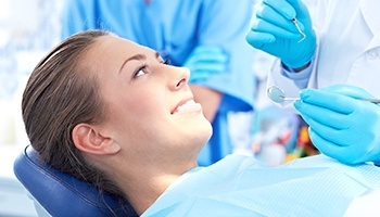 Relaxed woman in dental chair smiling warmly