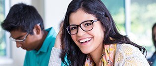 Lady sporting glasses jovially laughing