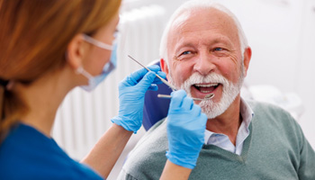Man smiles at dentist