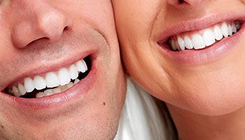 close-up of couple’s white smiles