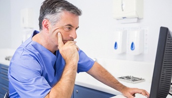 A dentist performing a virtual consult with a patient.