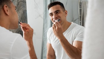 a man brushing his teeth