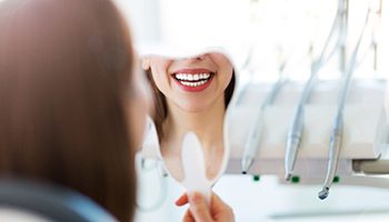 Woman smiling in mirror in Metairie