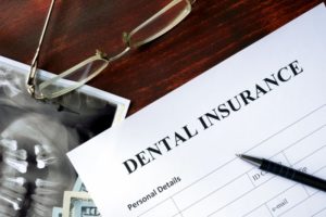 A dental insurance document next to an X-ray.