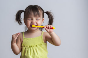 Little girl toothbrushing during National Children's Dental Health Month