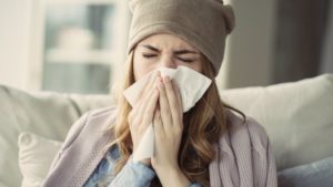 woman blowing her nose 