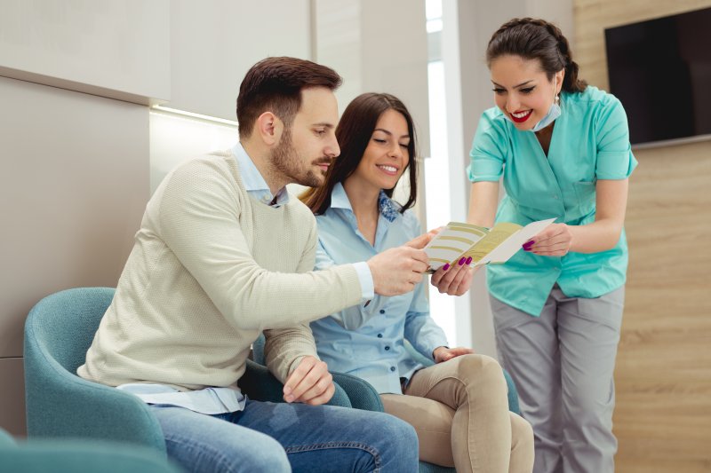 patients discussing dental insurance with receptionist