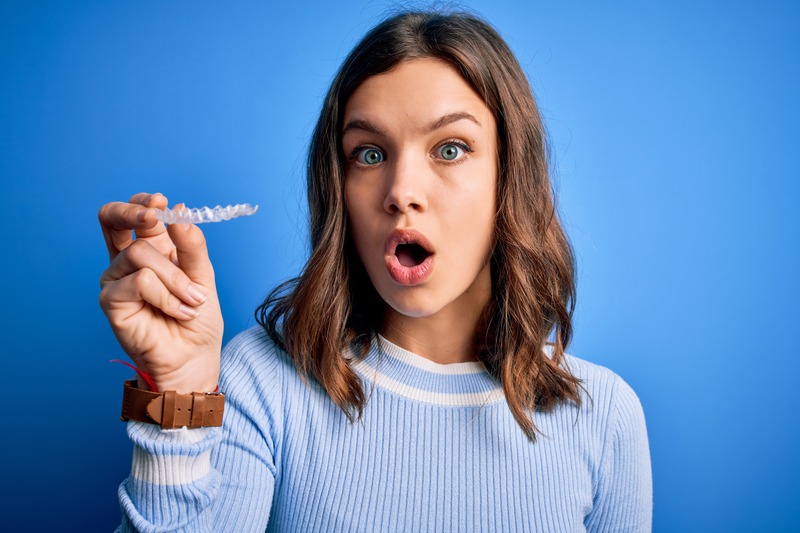 Patient putting in their Invisalign aligners